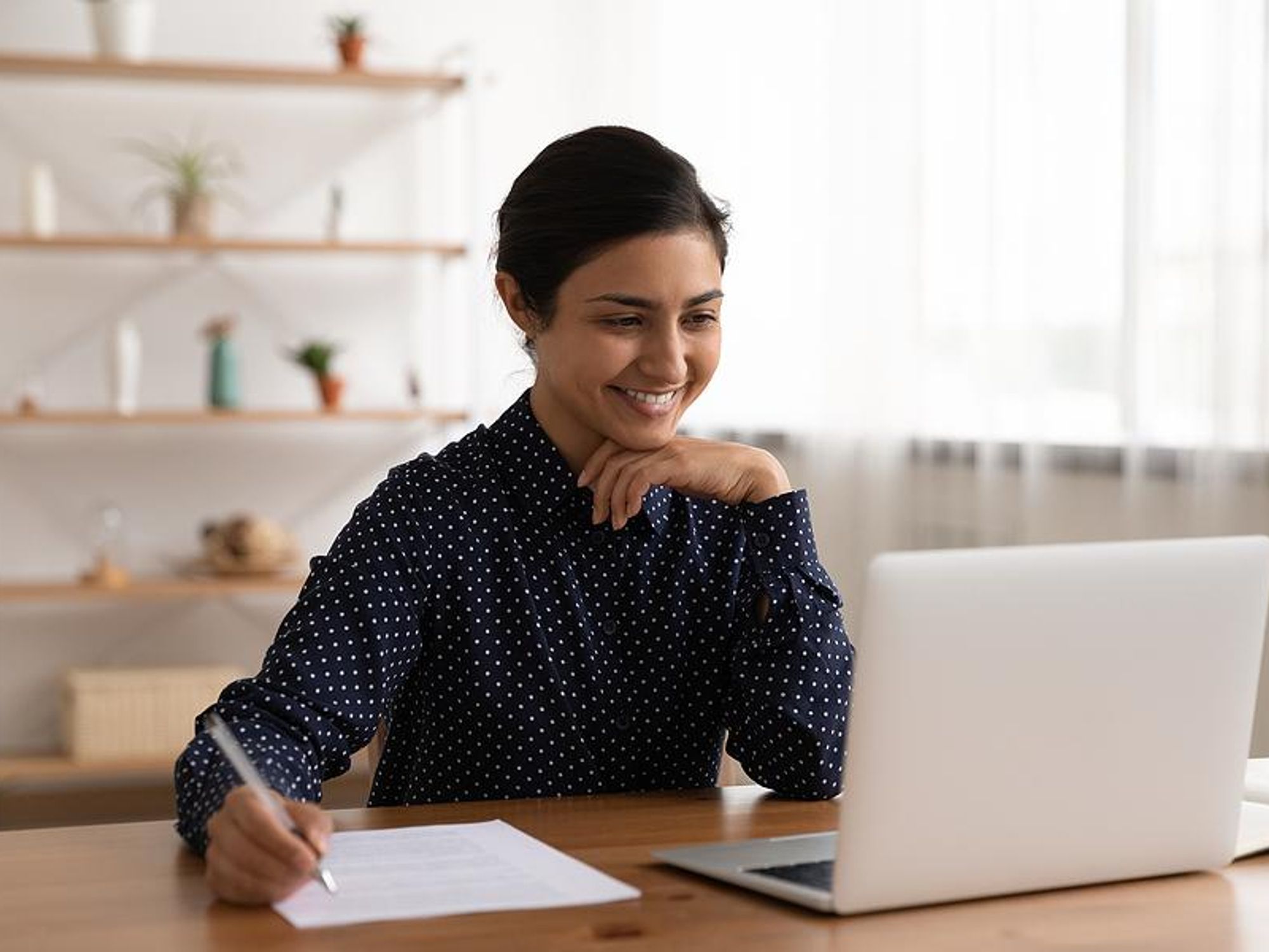 Woman edits her resume while looking for a job