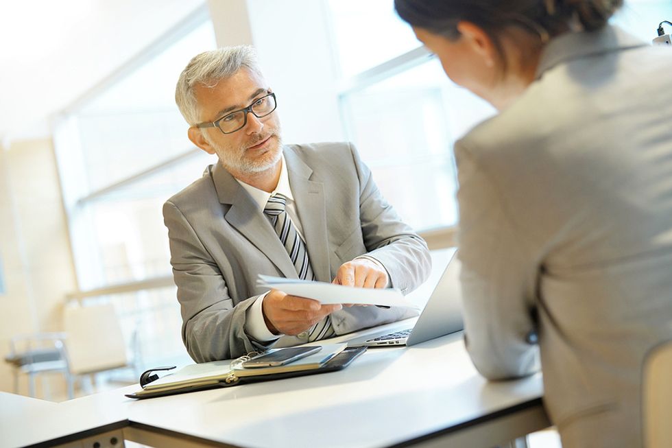 Woman gets feedback on her career from her boss during a performance review