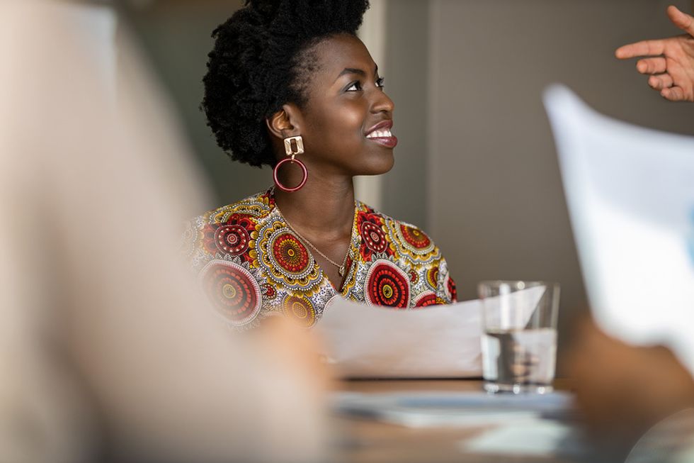 Woman gets ready to contribute and stand out during a work meeting