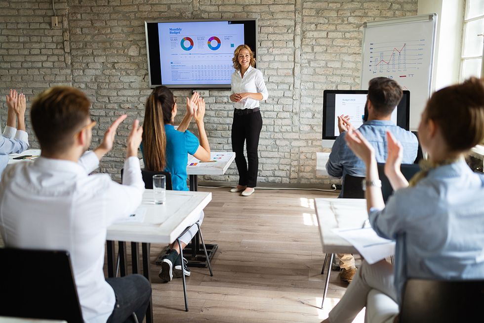 Woman gives a presentation about the learning & development industry