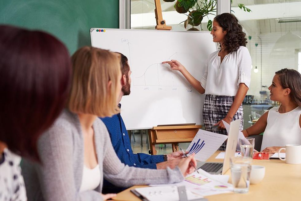 Woman gives a sales presentation to potential customers