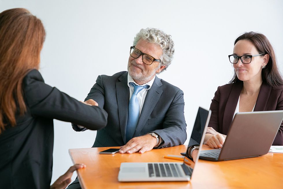 Woman greets hiring manager during a job interview