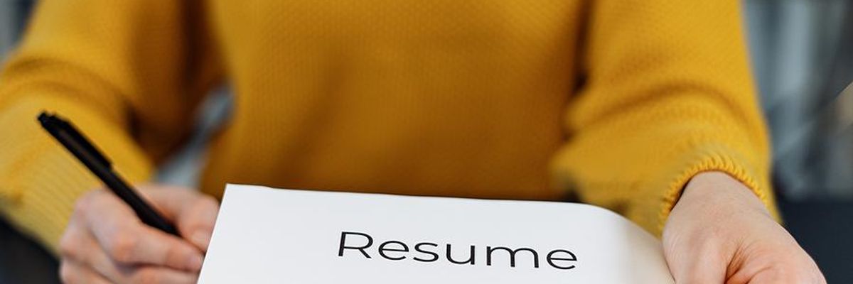 Woman hands her resume to the hiring manager