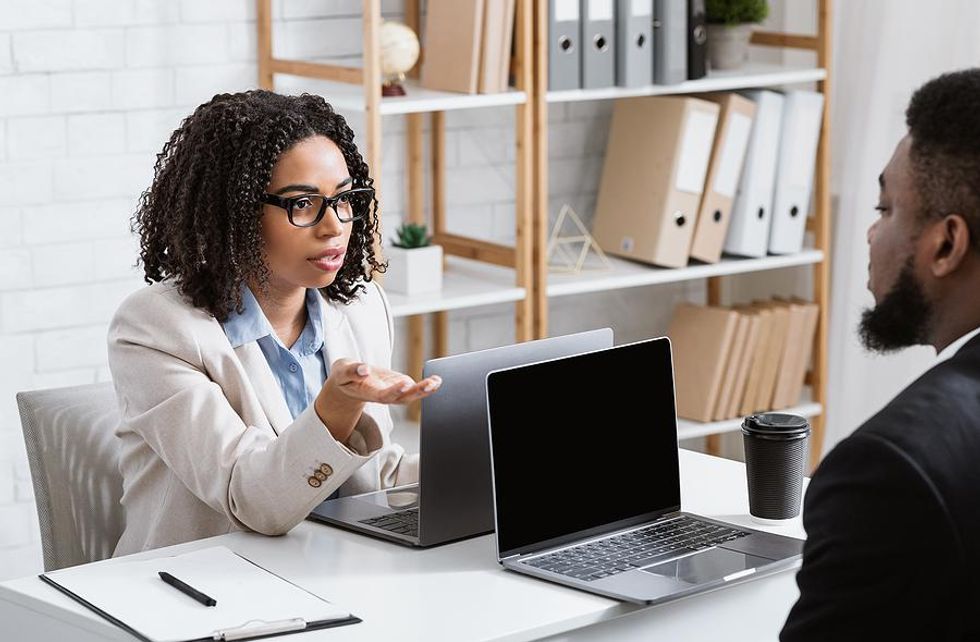 Woman helps a colleague resolve a conflict at work