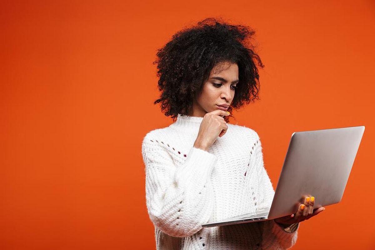 Woman holding laptop looks for a job