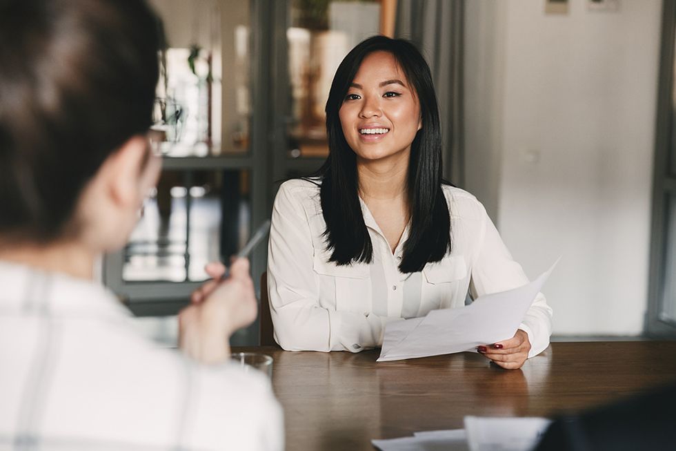 Woman holds a resume during an interview