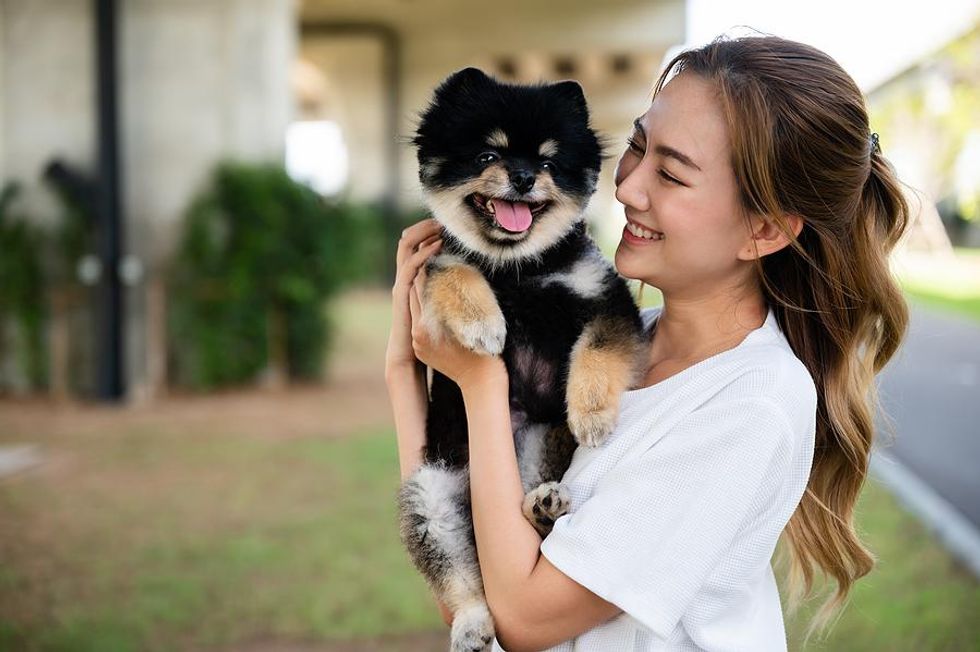 Woman holds her pet dog