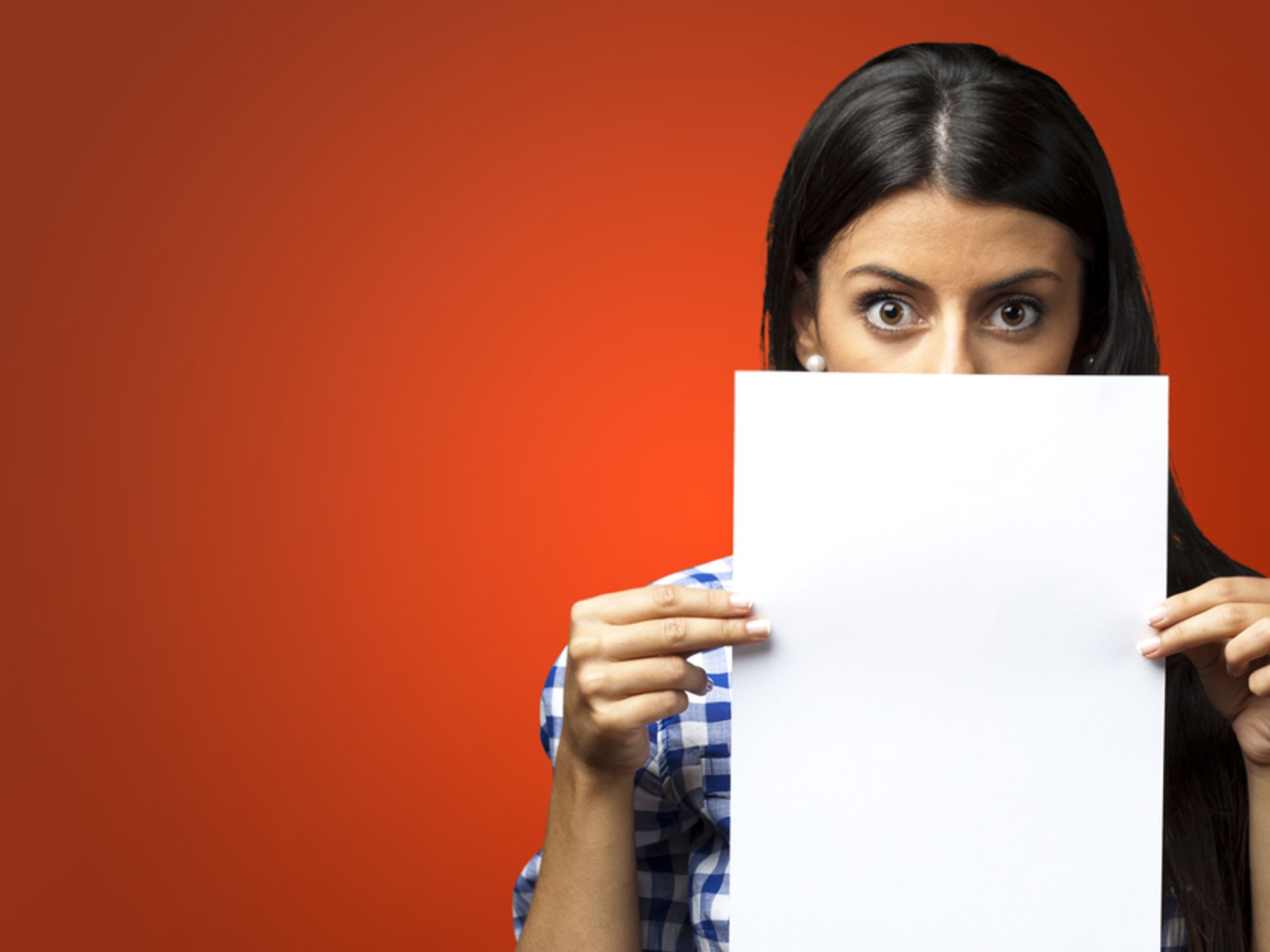 Woman holds up her resume free of the common resume mistakes every job seeker should avoid