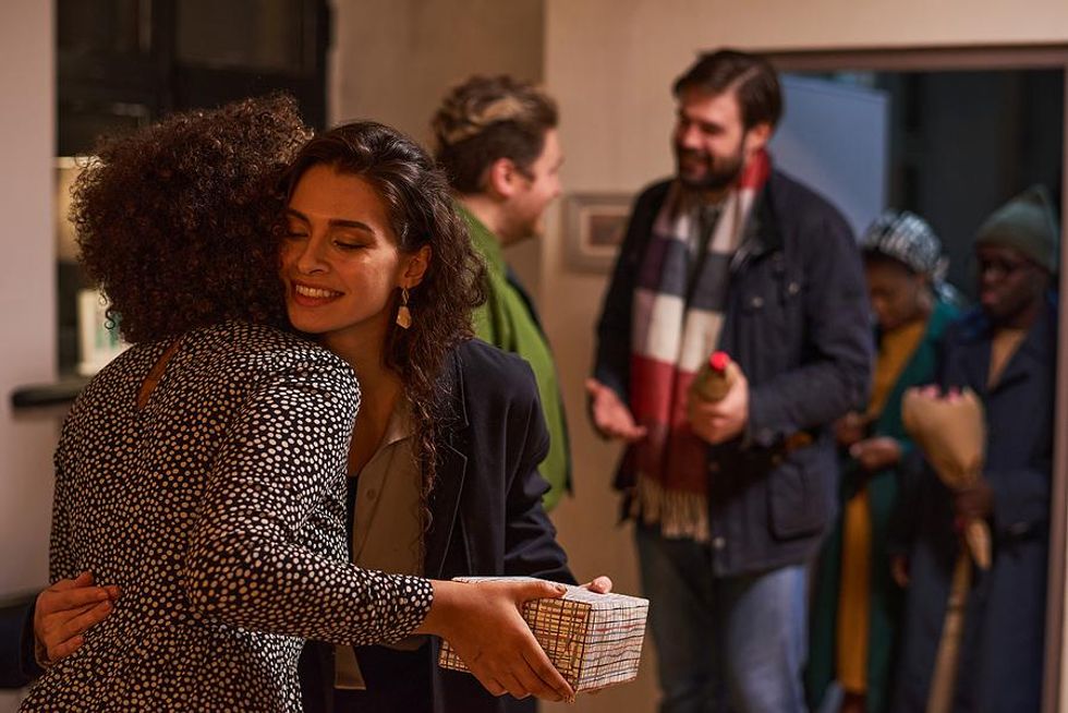 Woman hugs a family member at a party