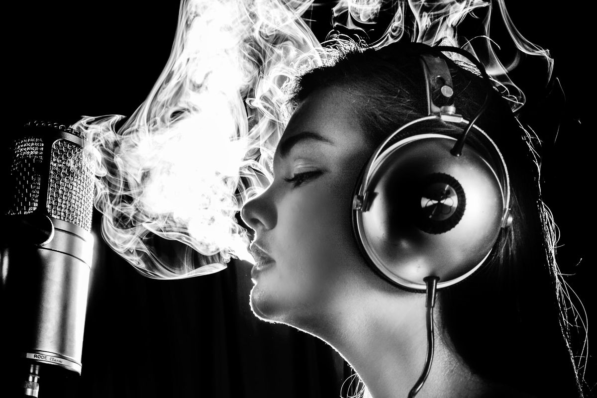 Woman in music studio smokes
