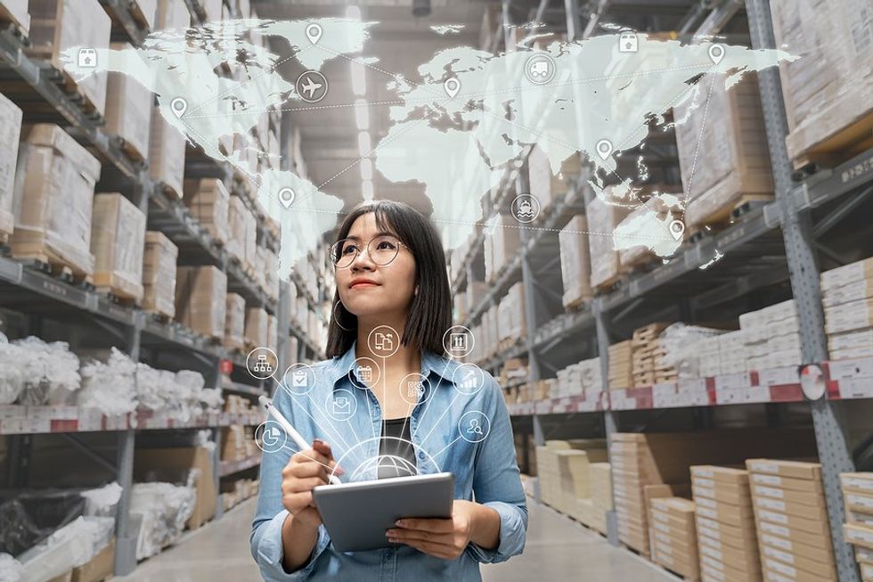 Woman in warehouse thinks about supply chain management