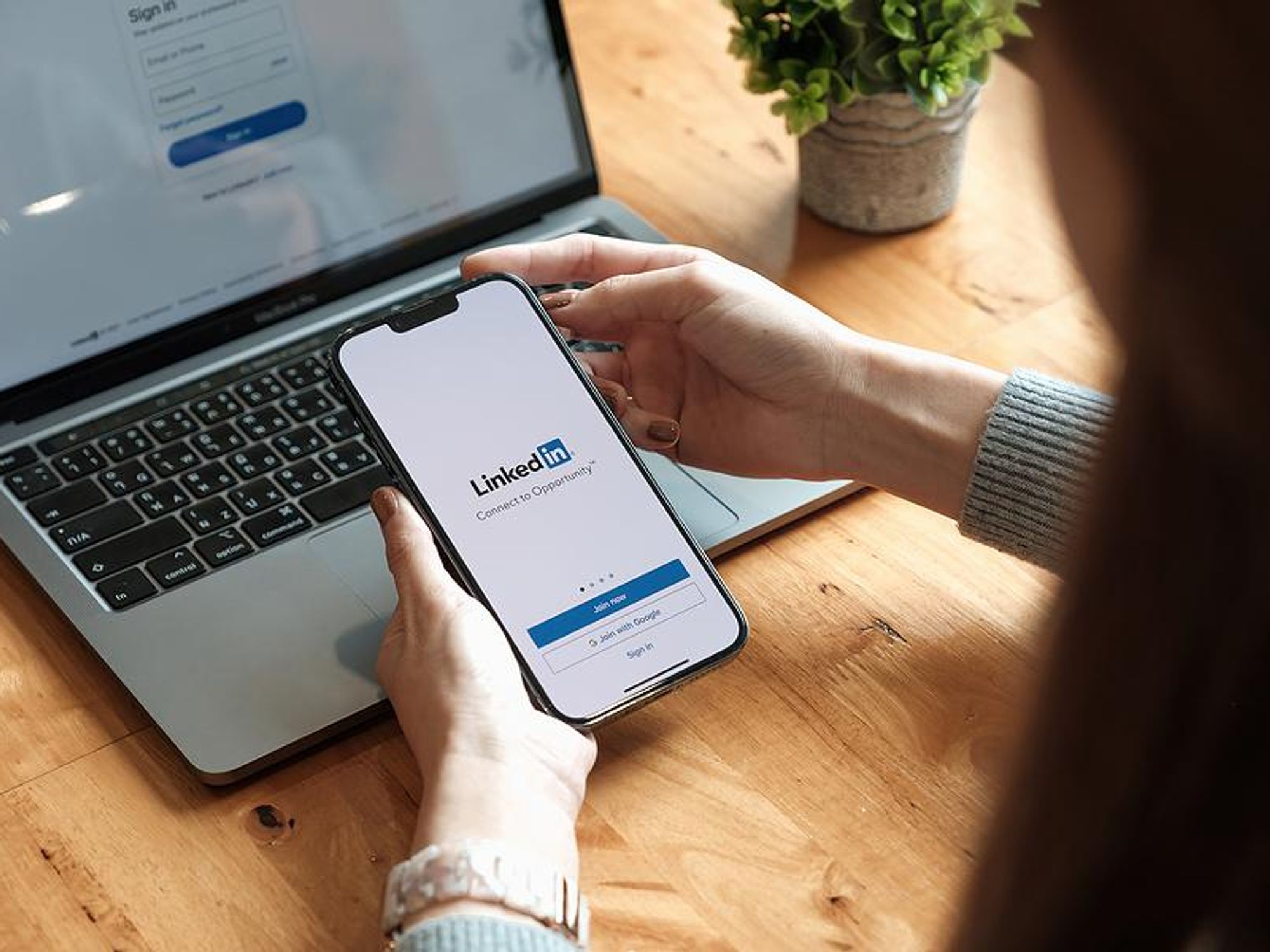 Woman joins and opens LinkedIn on her phone