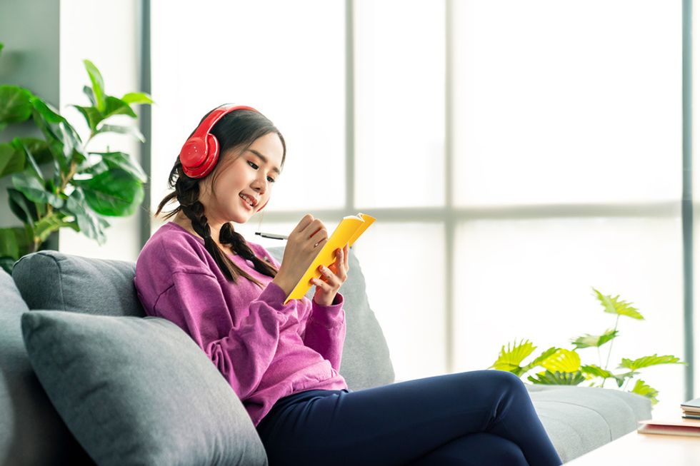 Woman listens to a professional development podcast