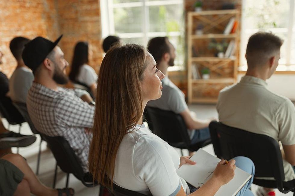 Woman listens to a public speaker