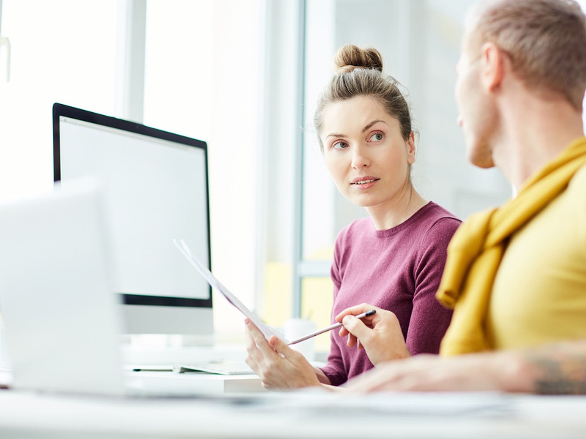 Woman listens to her co-worker give her directions