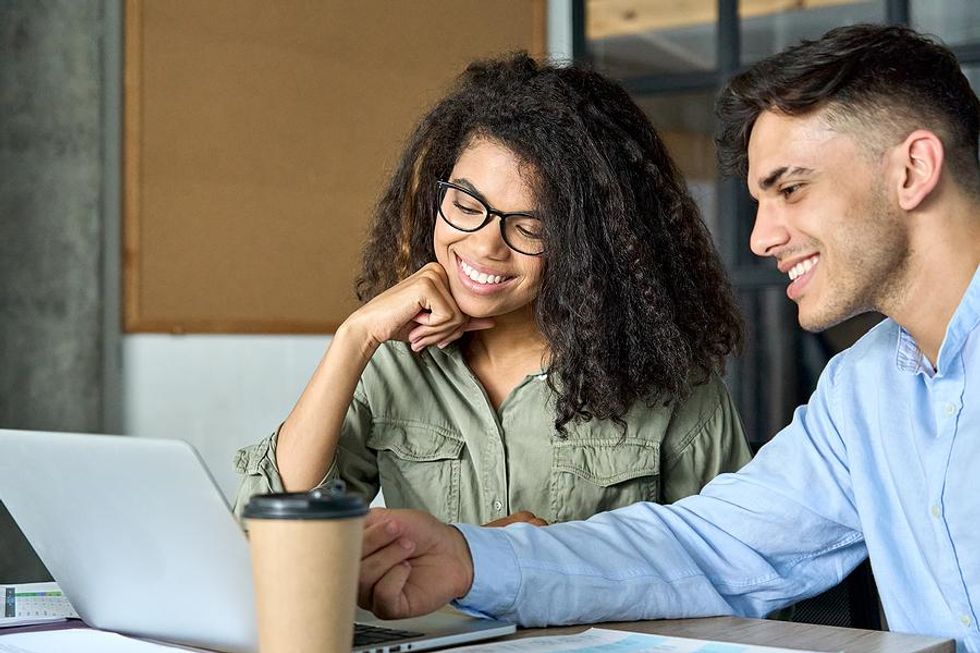 Woman listens to her coworker/friend at work