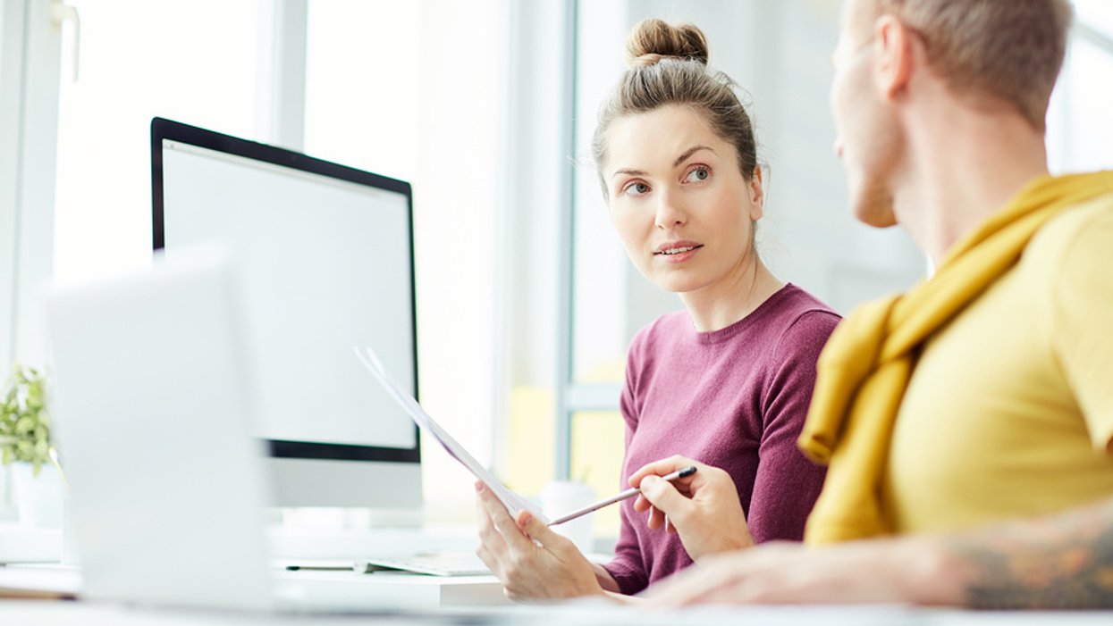 Woman listens to her coworker give her directions