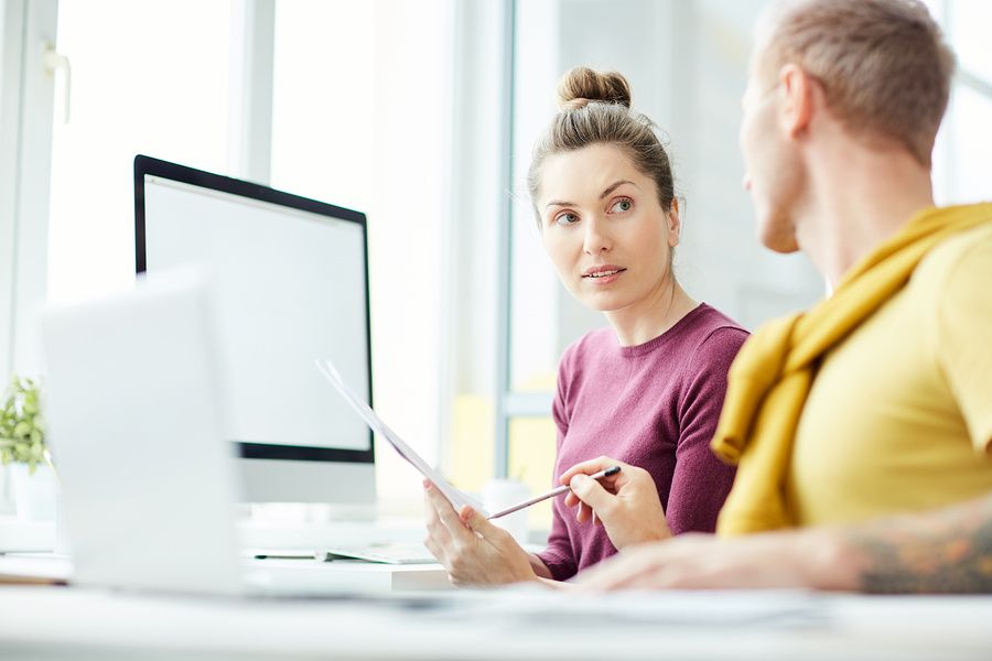 Woman listens to her coworker give her directions