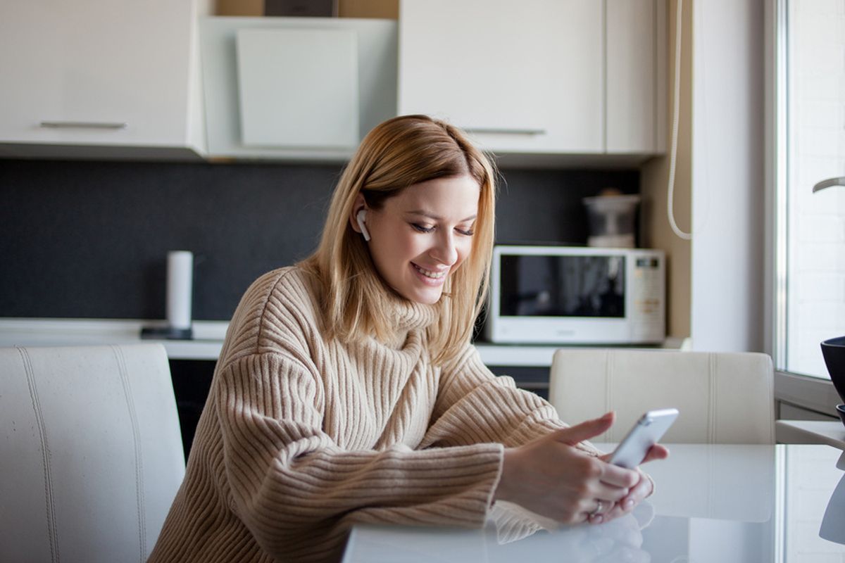 Woman listens to inspiring podcast episodes