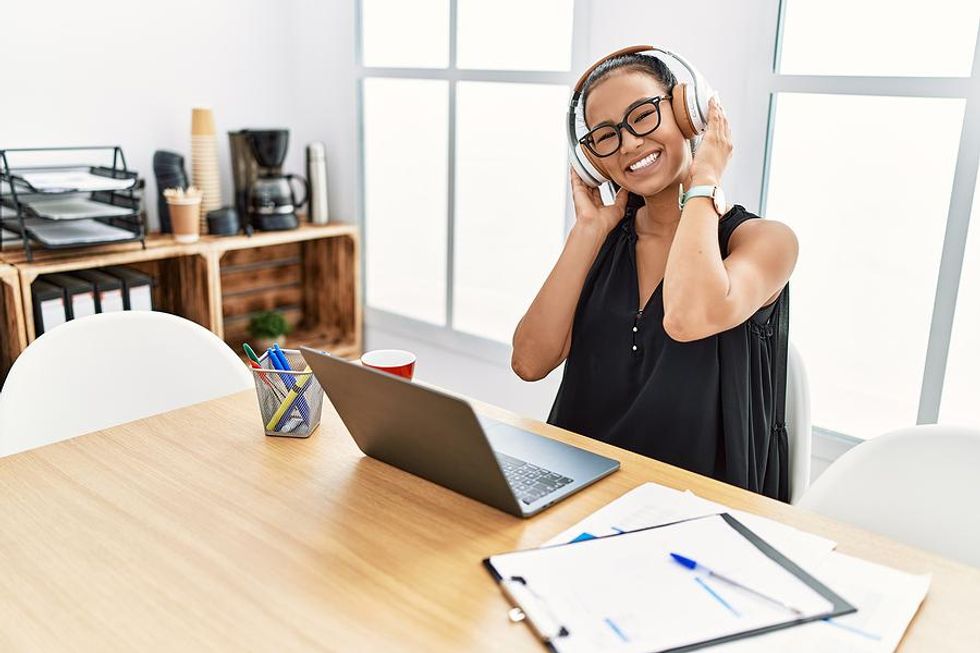 Woman listens to music at work