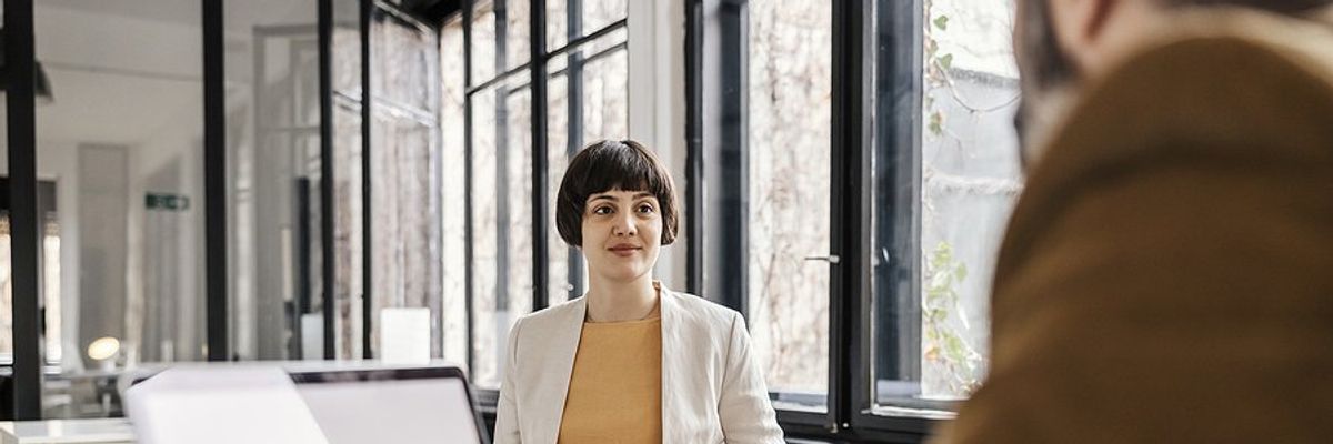 Woman listens to the hiring manager during a job interview