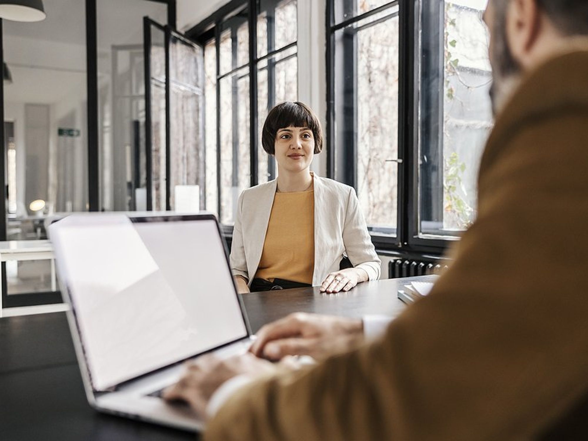 Woman listens to the hiring manager during a job interview