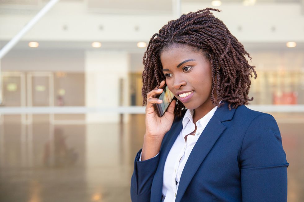 Woman listens while on a phone interview