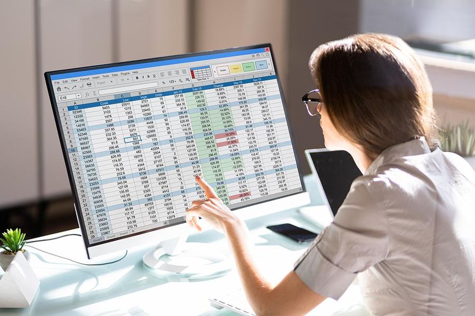 Woman looks at a spreadsheet on her computer