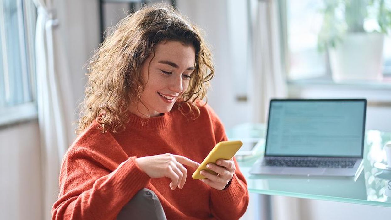 Woman looks at her LinkedIn profile on her phone