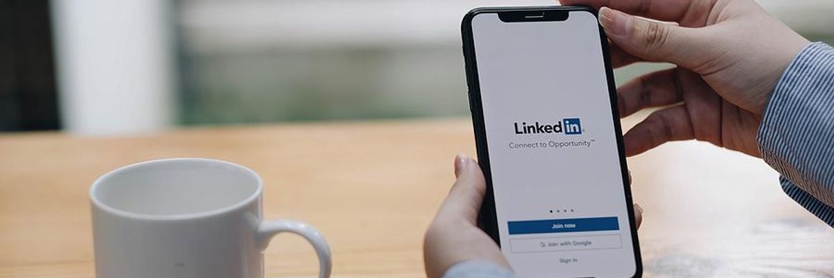 Woman looks at LinkedIn on her phone