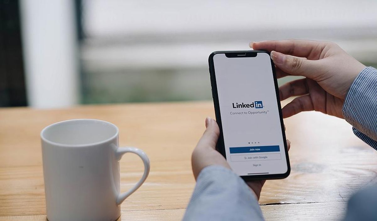 Woman looks at LinkedIn on her phone