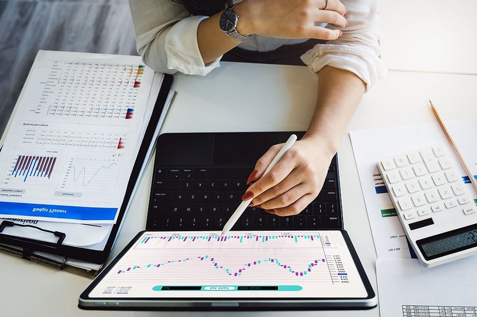 Woman monitors risk on her laptop