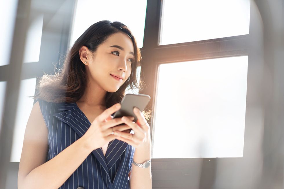 Woman networks on her phone