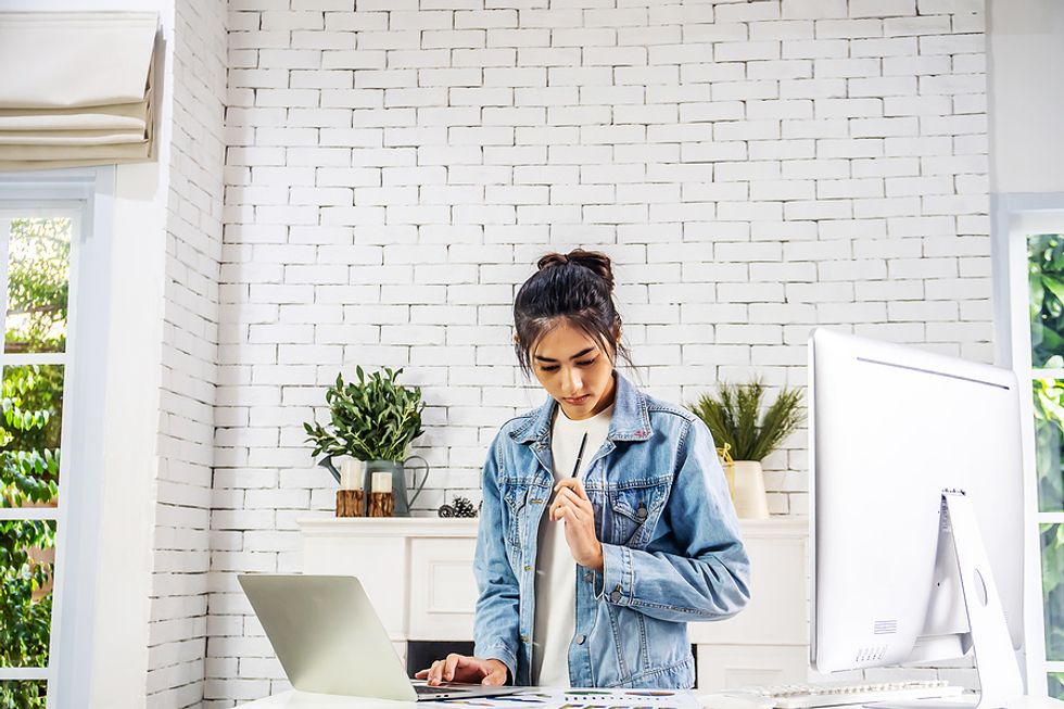 Woman on laptop applies for more jobs during a tough job search