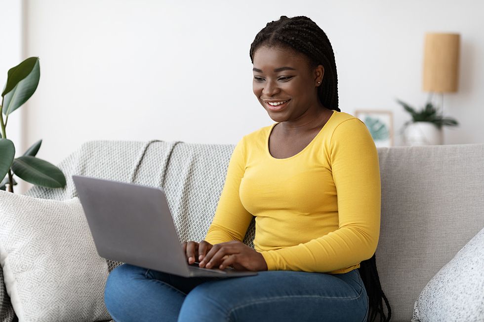 Woman on laptop avoids writing "To Whom It May Concern" on her cover letter