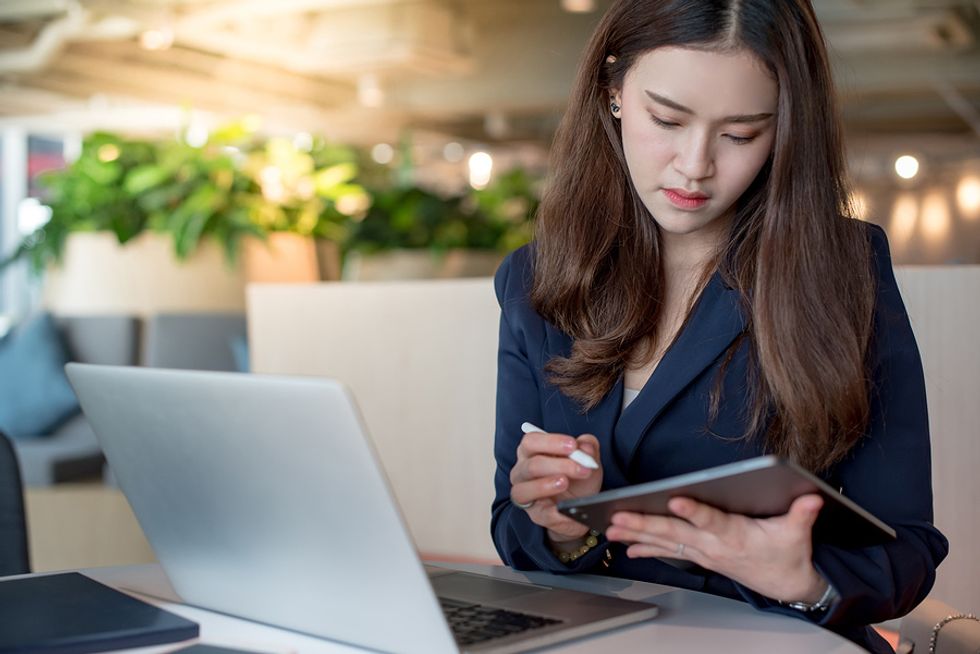 Woman on laptop changes her LinkedIn headline