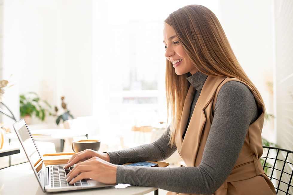 Woman on laptop checks in with a connection on LinkedIn