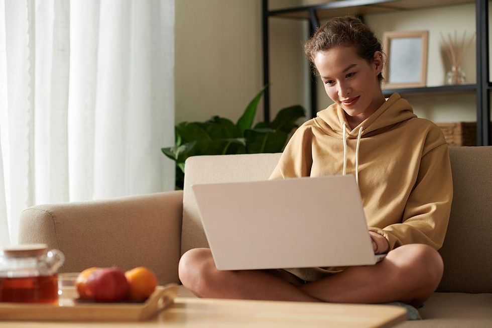 Woman on laptop cleans up her resume