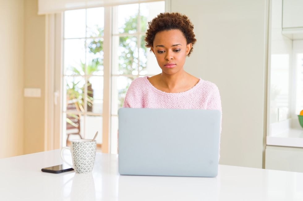 Woman on laptop concerned a recession may impact her career