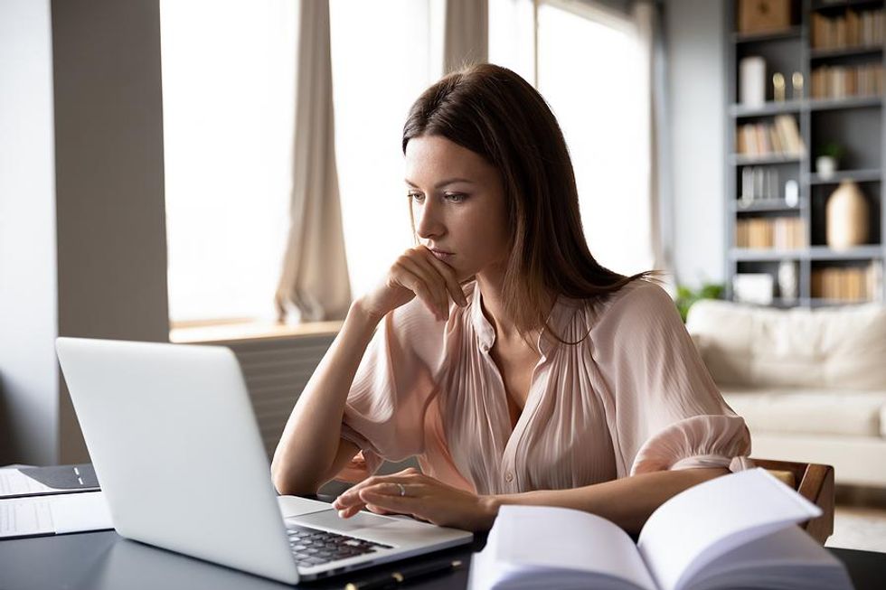 Woman on laptop connects with a company while researching for her job search