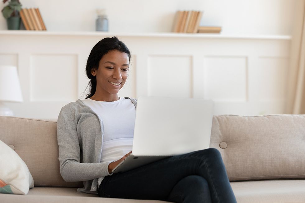 Woman on laptop edits her resume and LinkedIn profile