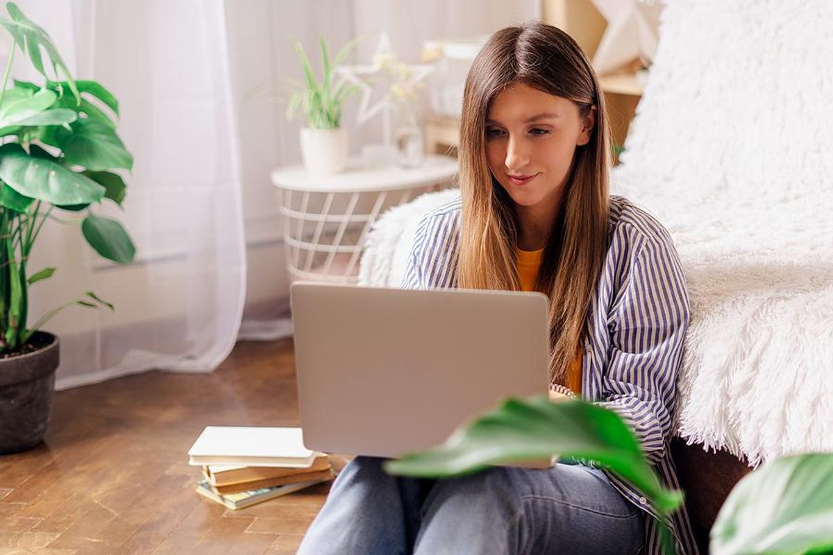 Woman on laptop edits her resume during the job search