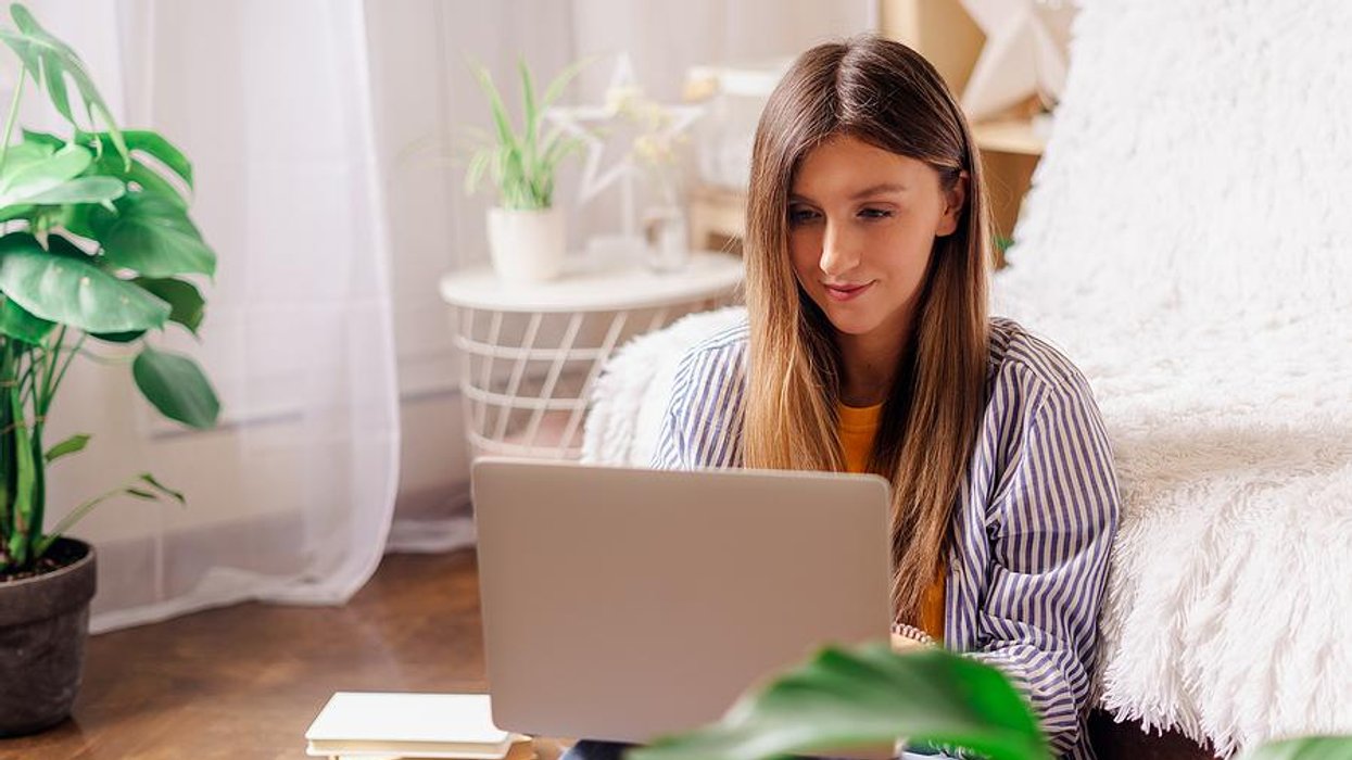 Woman on laptop edits her resume during the job search