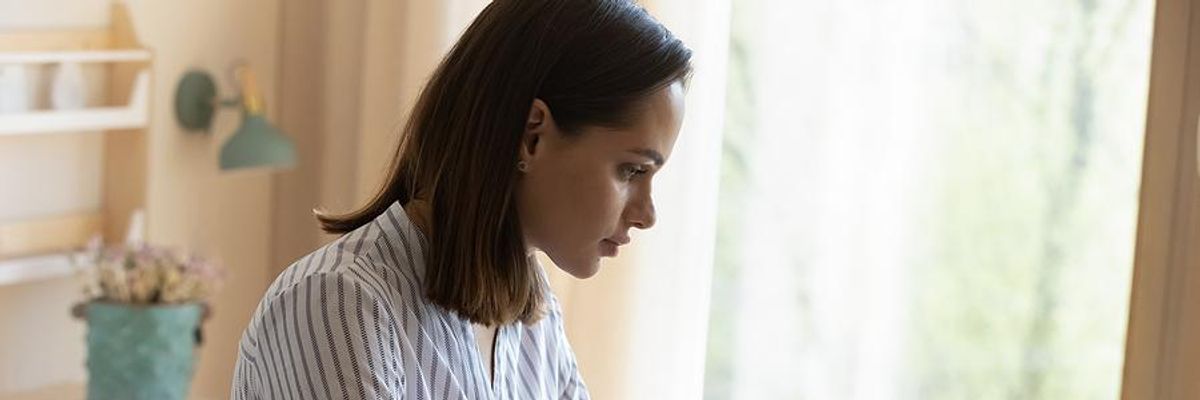 Woman on laptop emails her cover letter to an employer