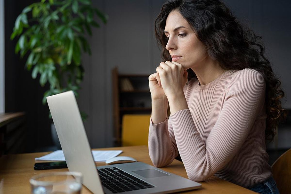 Woman on laptop fills out an online job application
