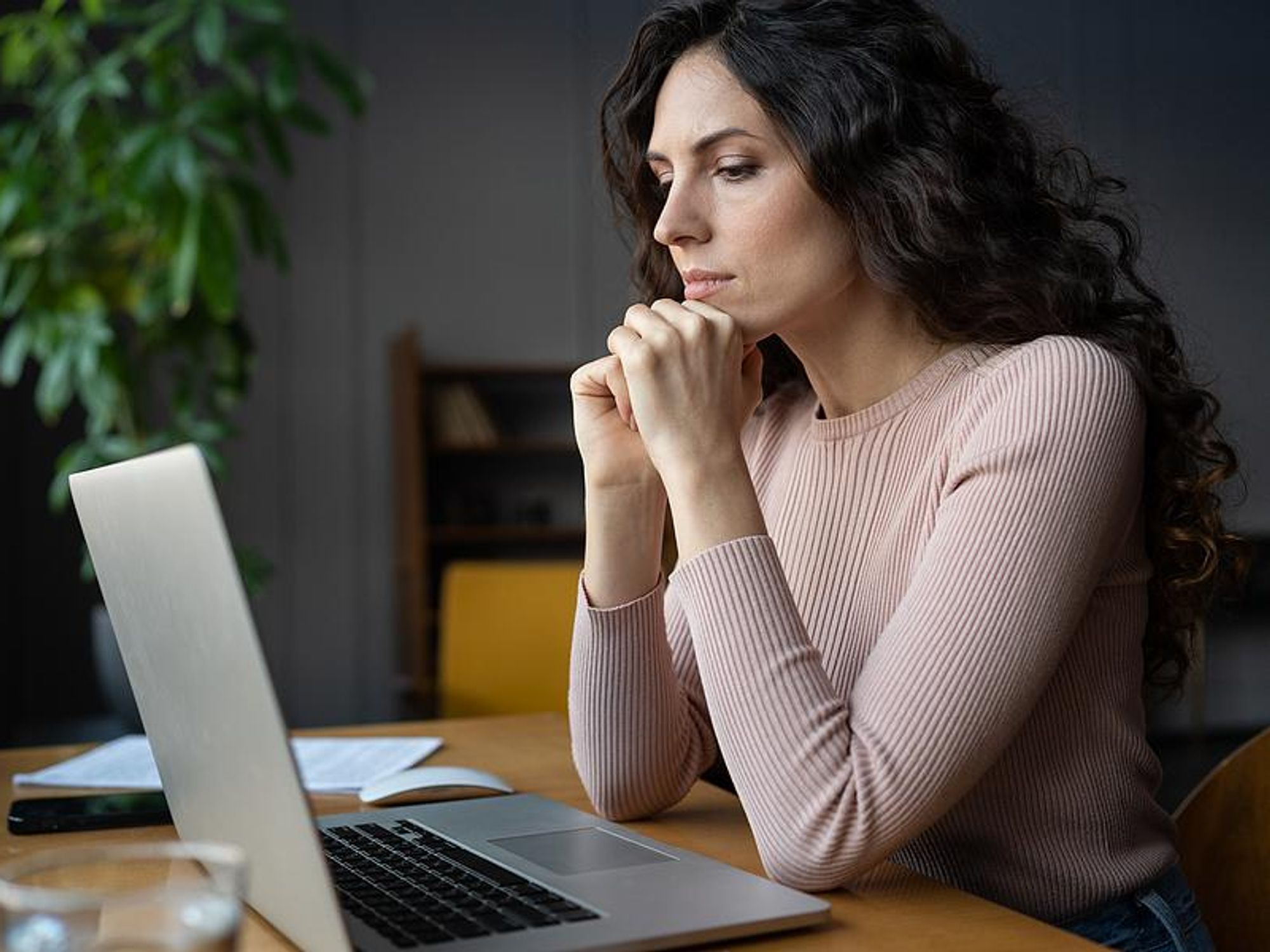 Woman on laptop fills out an online job application