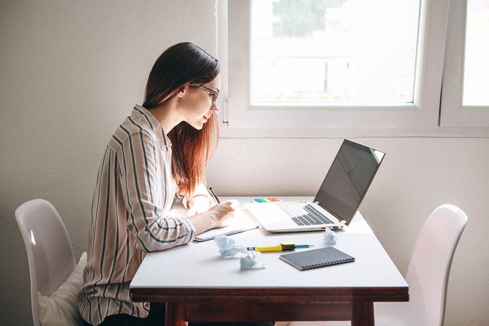 Woman on laptop focuses on a project while working from home