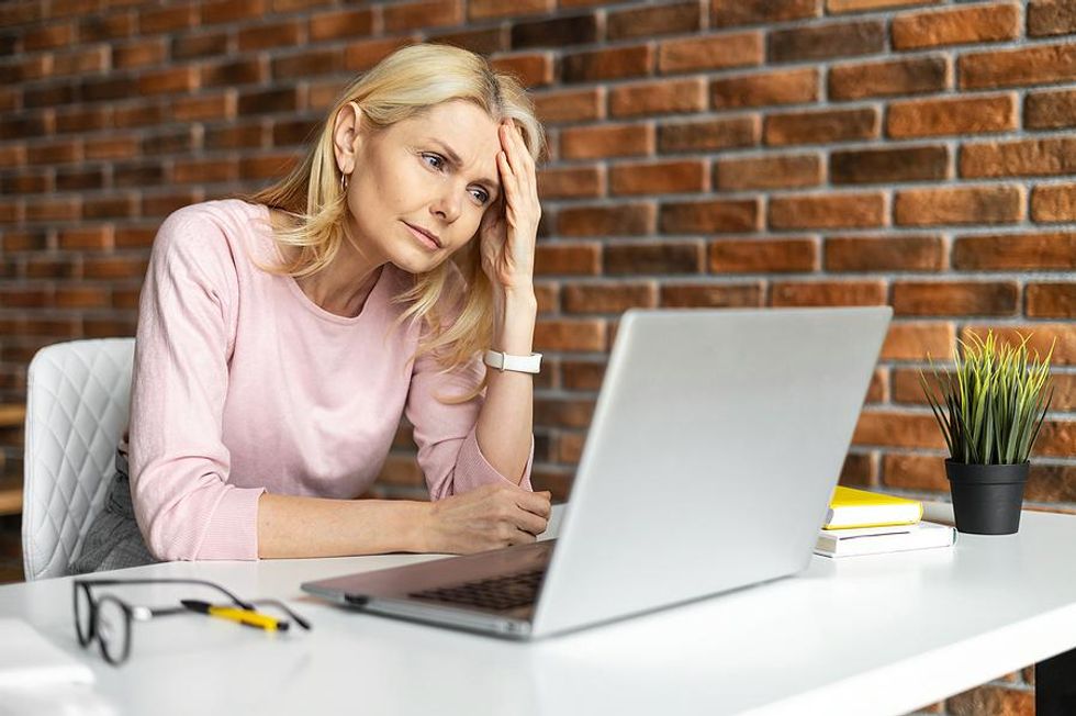Woman on laptop frustrated about confusing resume words