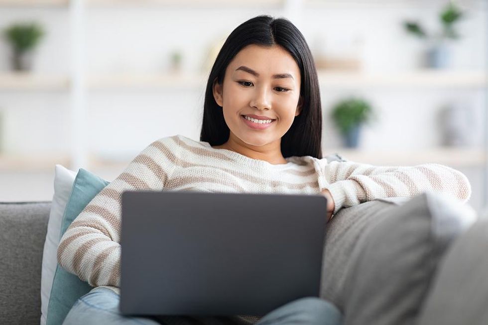 Woman on laptop introduces two people in her network