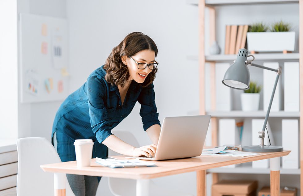 Woman on laptop invites someone to connect on LinkedIn